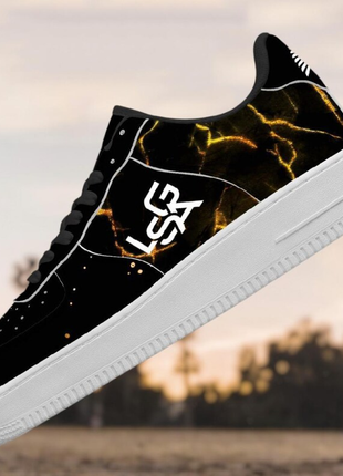 The LIONSGALA - LSGA Dorado Bolted Gold streetwear sneakers by LIONSGALA Brands feature black premium leather, a glowing yellow lightning pattern, white sole, and stylized LS initials—perfect for sneaker lovers seeking standout style.