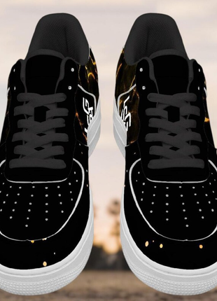 The LIONSGALA - LSGA Dorado Bolted Gold streetwear sneakers by LIONSGALA Brands feature premium leather, white soles and laces, and a pattern of small yellow and orange dots, shown against a blurred outdoor backdrop.